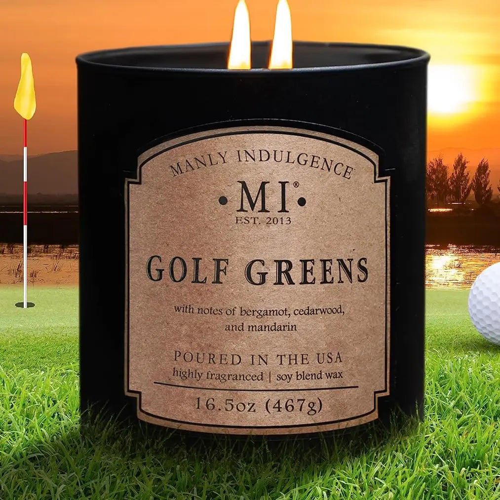 Candle labeled 'Golf Greens' by Manly Indulgence on a golf course with sunset background