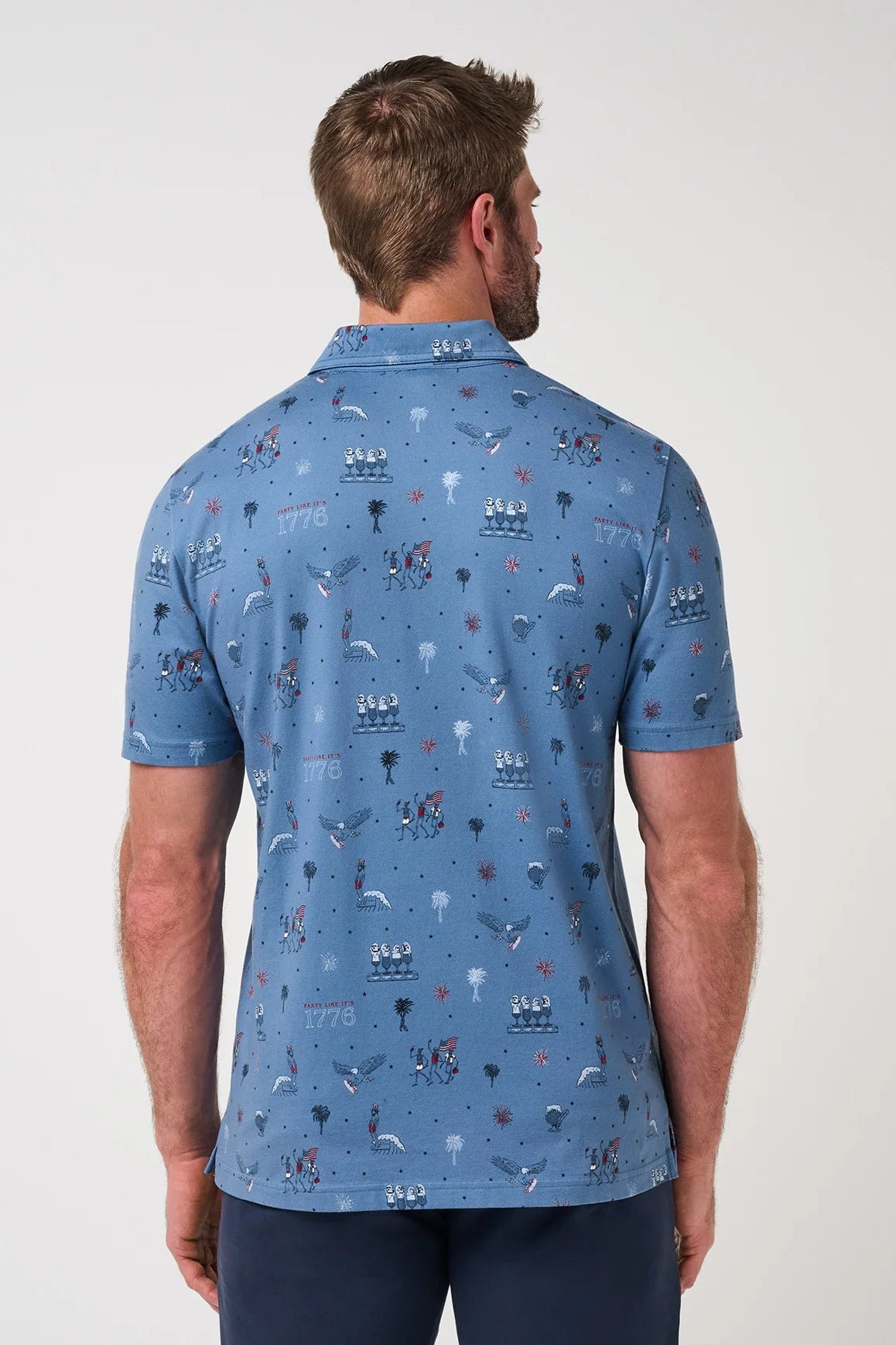 Man wearing a blue patterned polo shirt on a white background