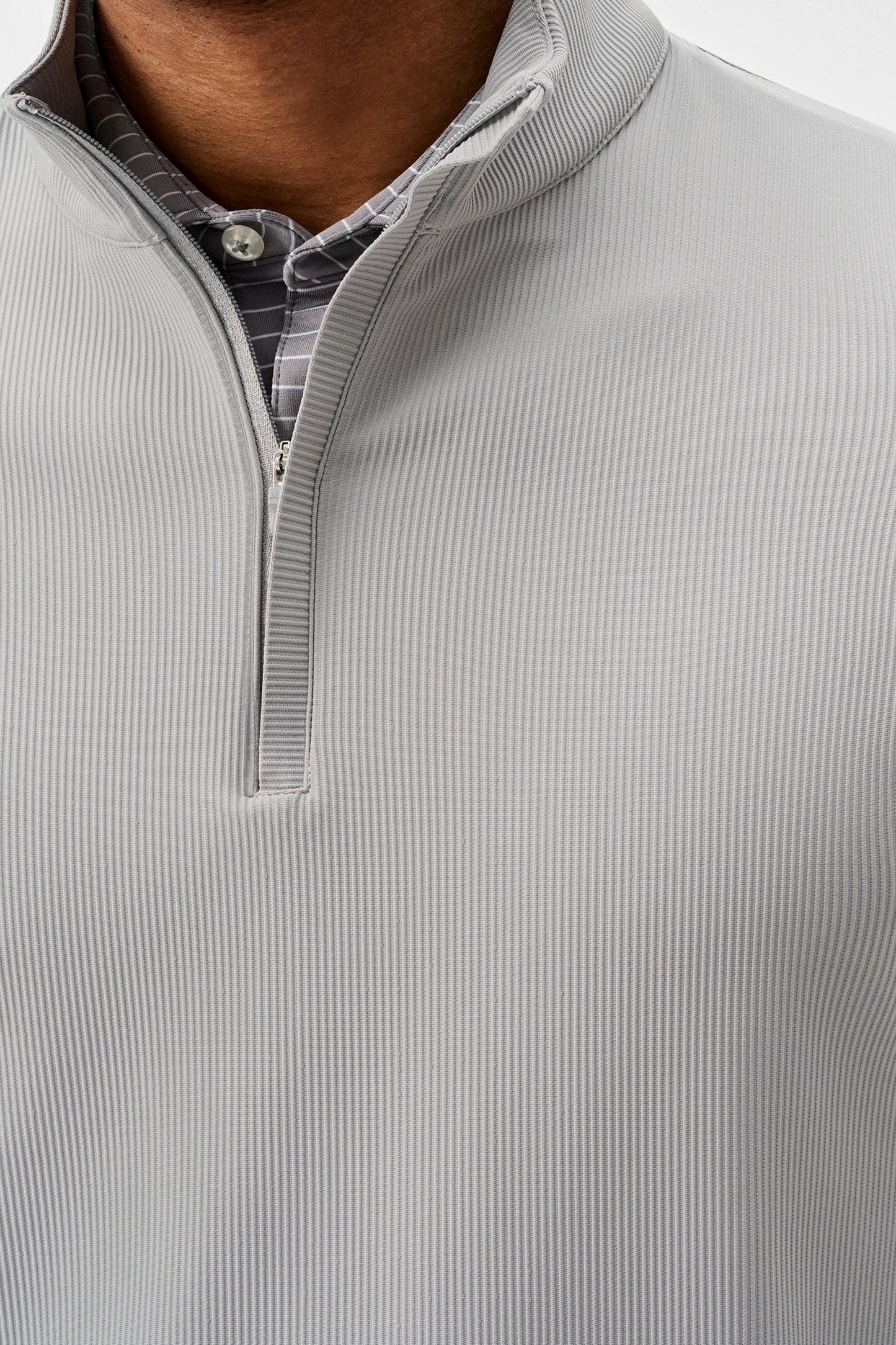 Close-up of a gray ribbed pullover with a quarter zip.