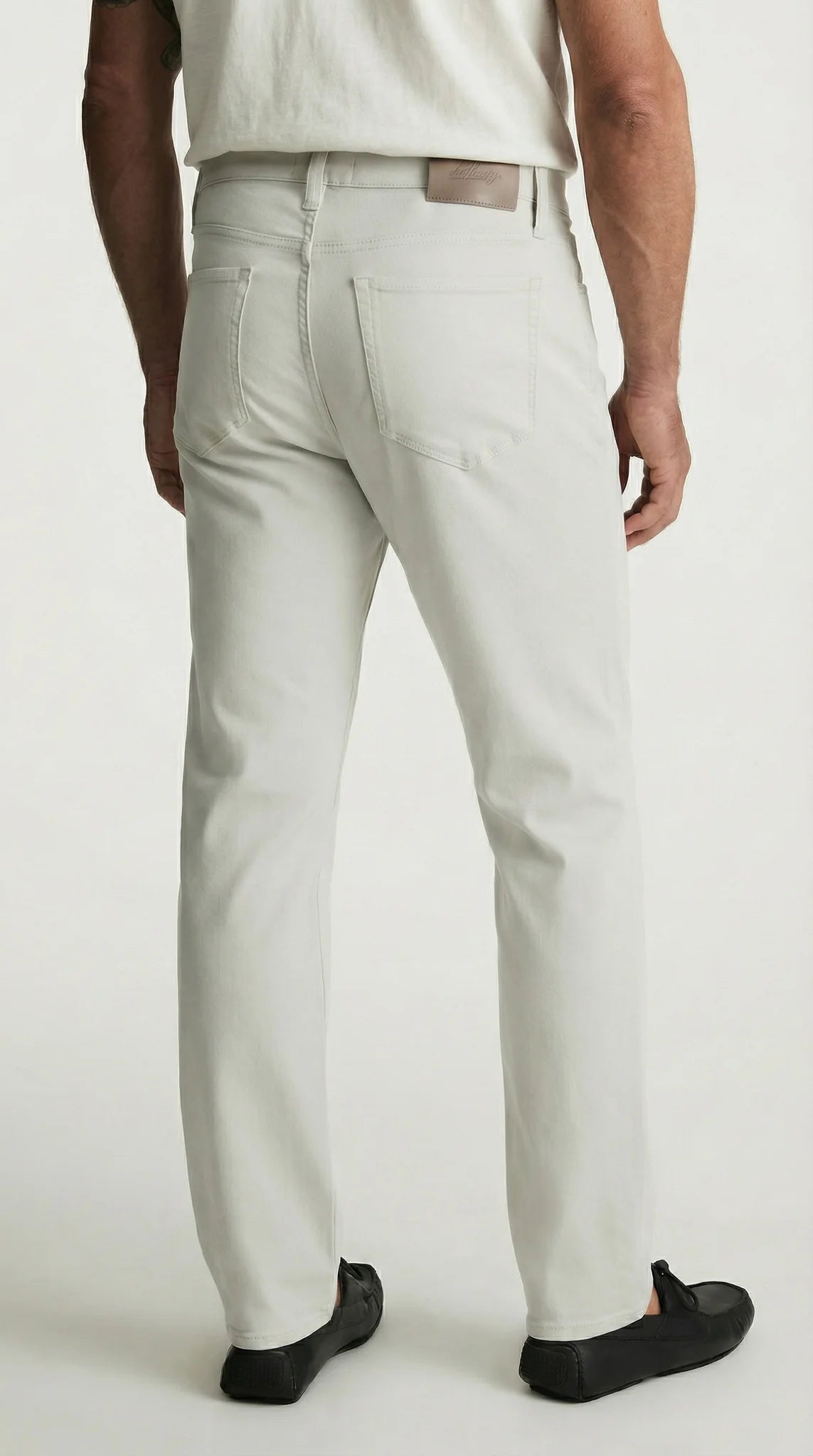 Person wearing light gray pants on a white background