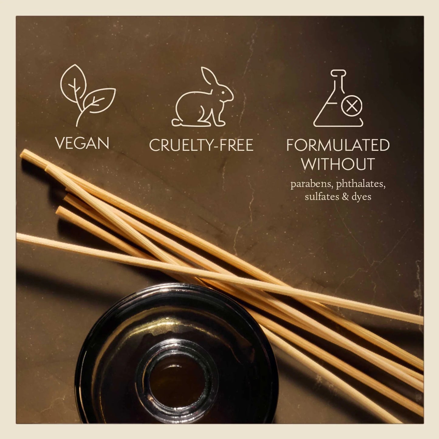 Natural wood incense sticks arranged on a dark brown textured surface next to a black glass dish, with white line icons and text above stating Vegan, Cruelty-Free, and Formulated Without parabens, phthalates, sulfates & dyes.