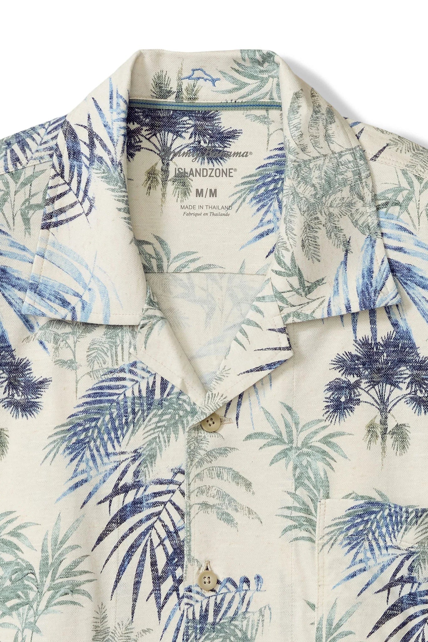 Short-sleeve shirt with tropical leaf pattern on a white background