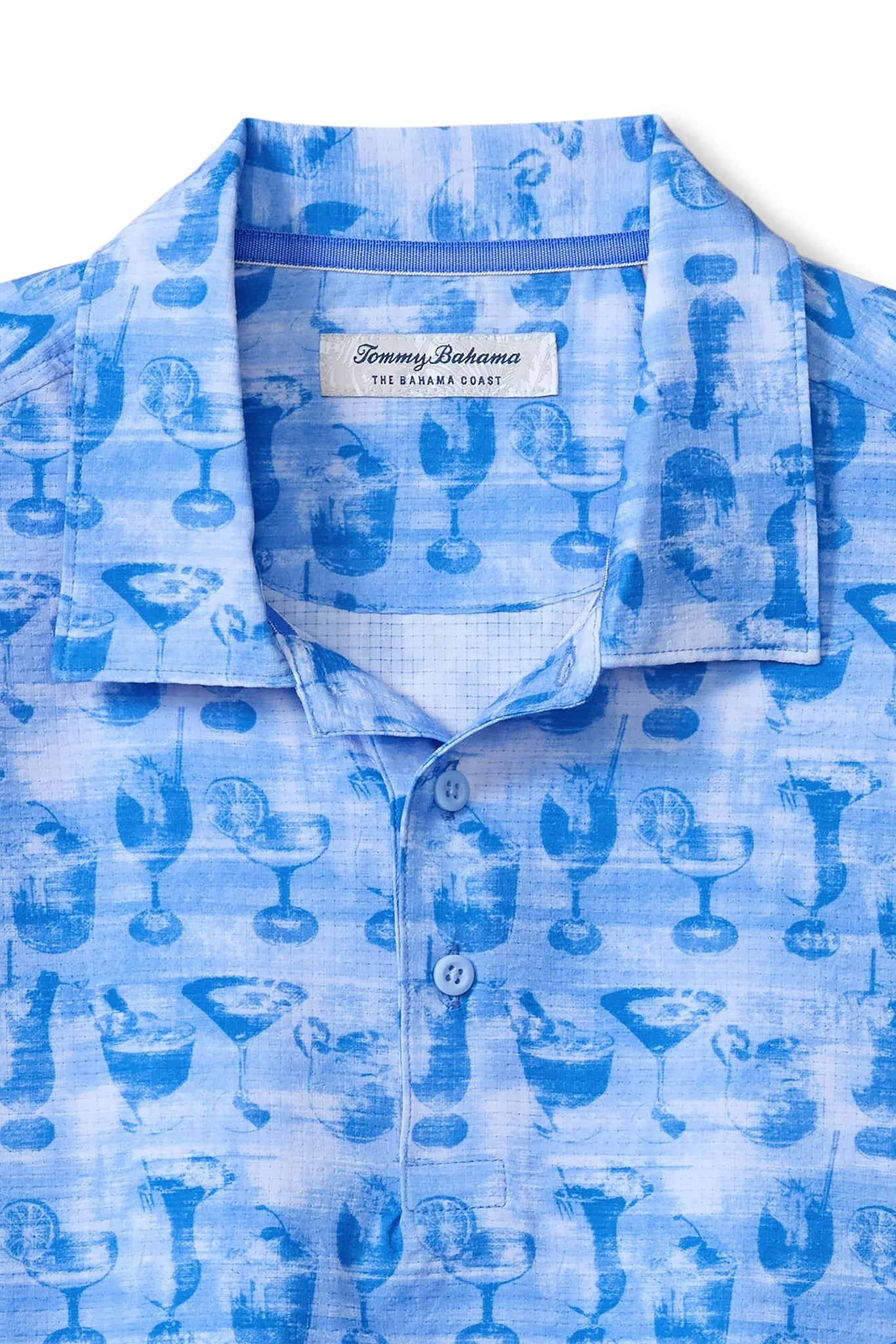 Blue patterned shirt with Tommy Bahama label on a white background