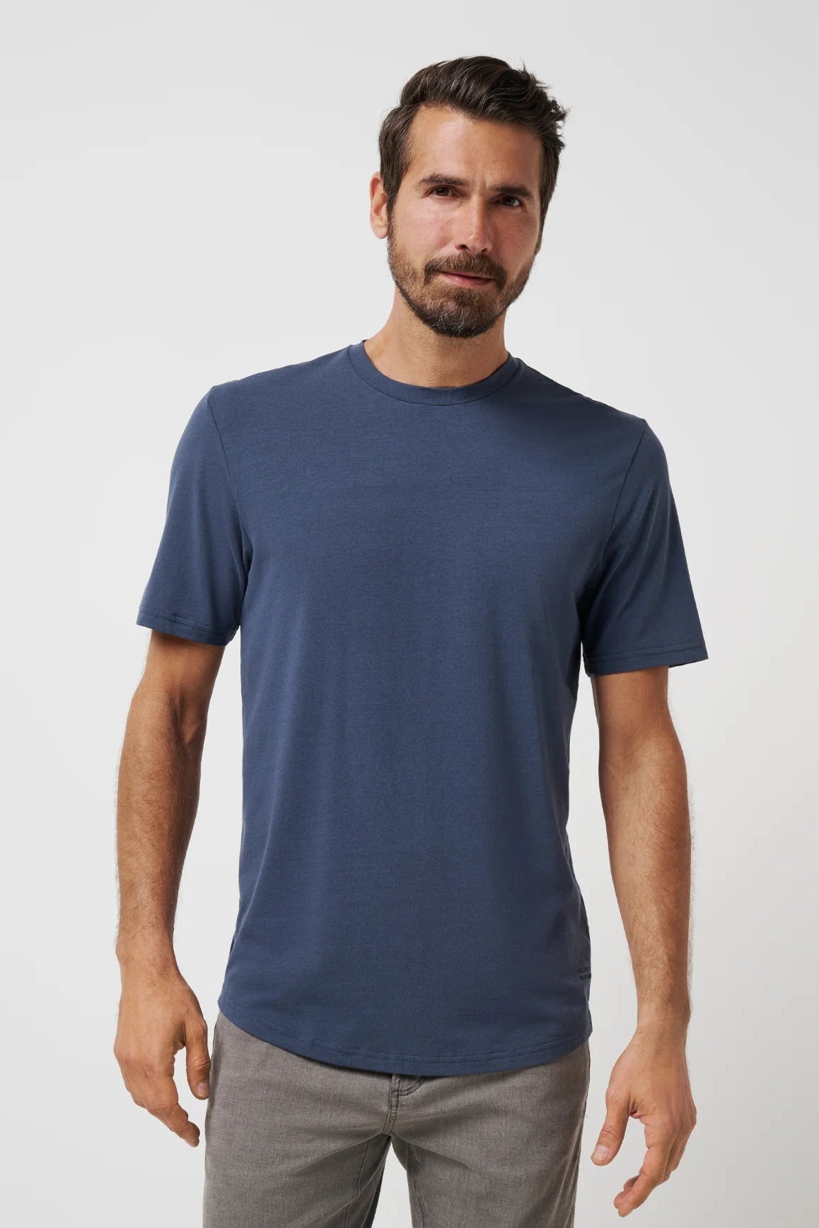 Man wearing a blue t-shirt against a plain background