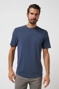 Man wearing a blue t-shirt against a plain background