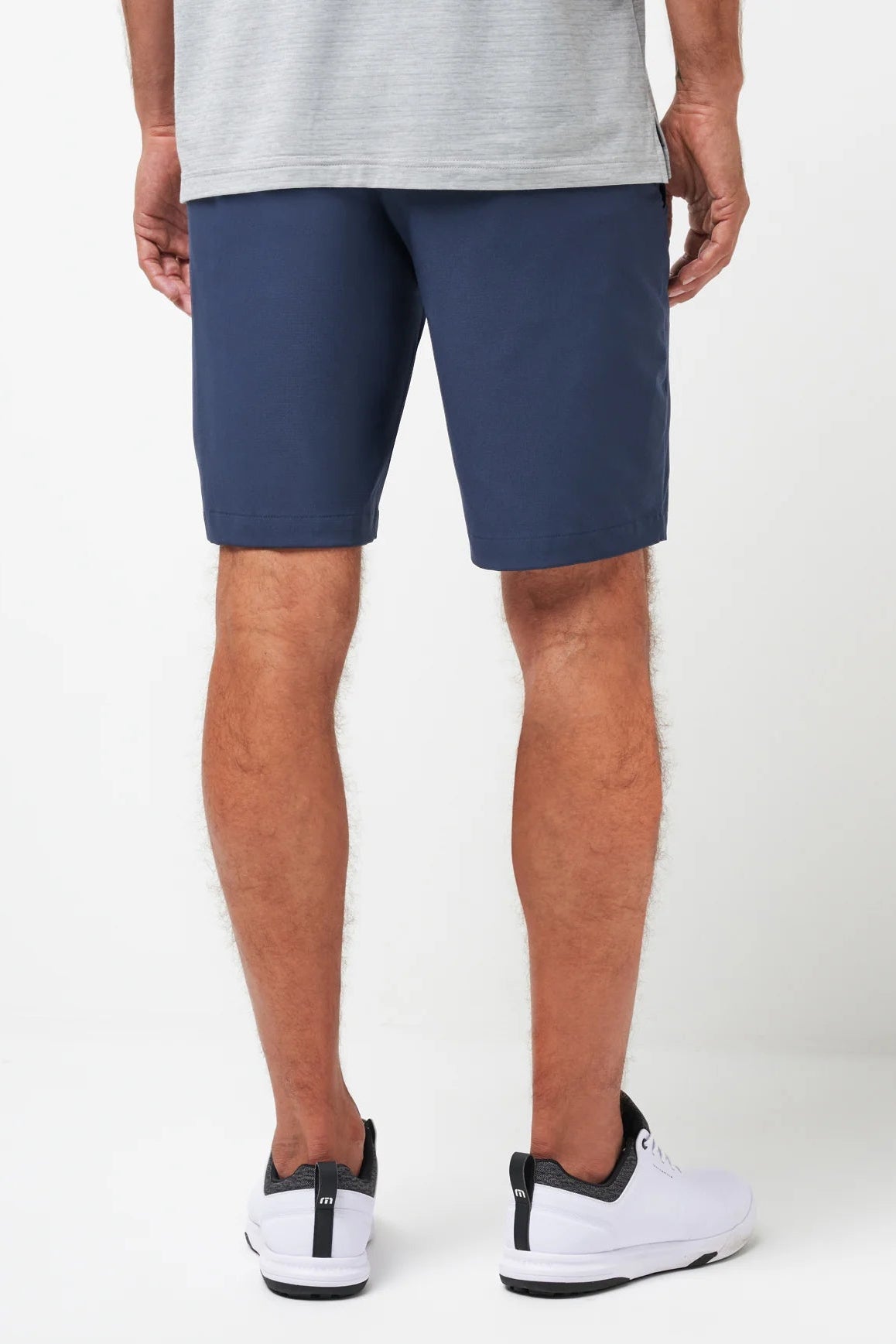 Person wearing navy shorts on a white background
