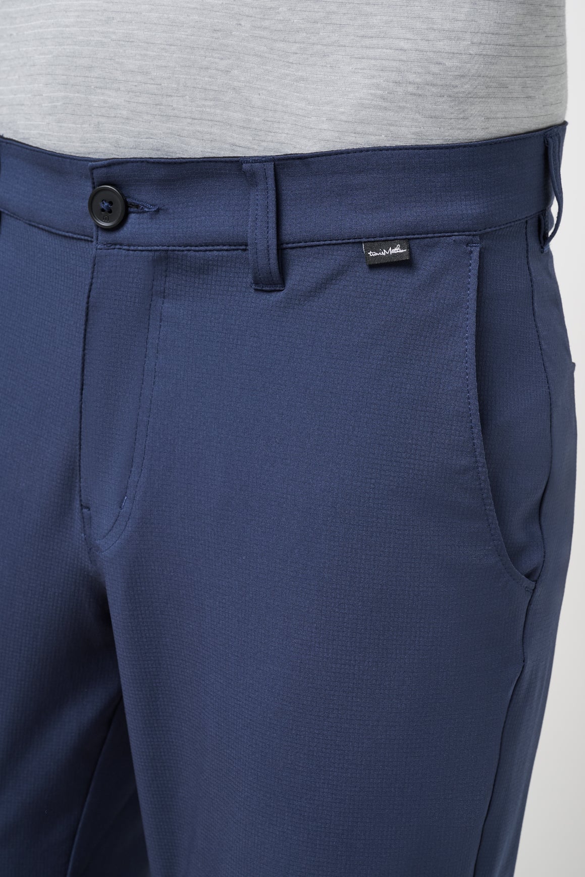 Navy blue pants with a brand logo on a light gray background