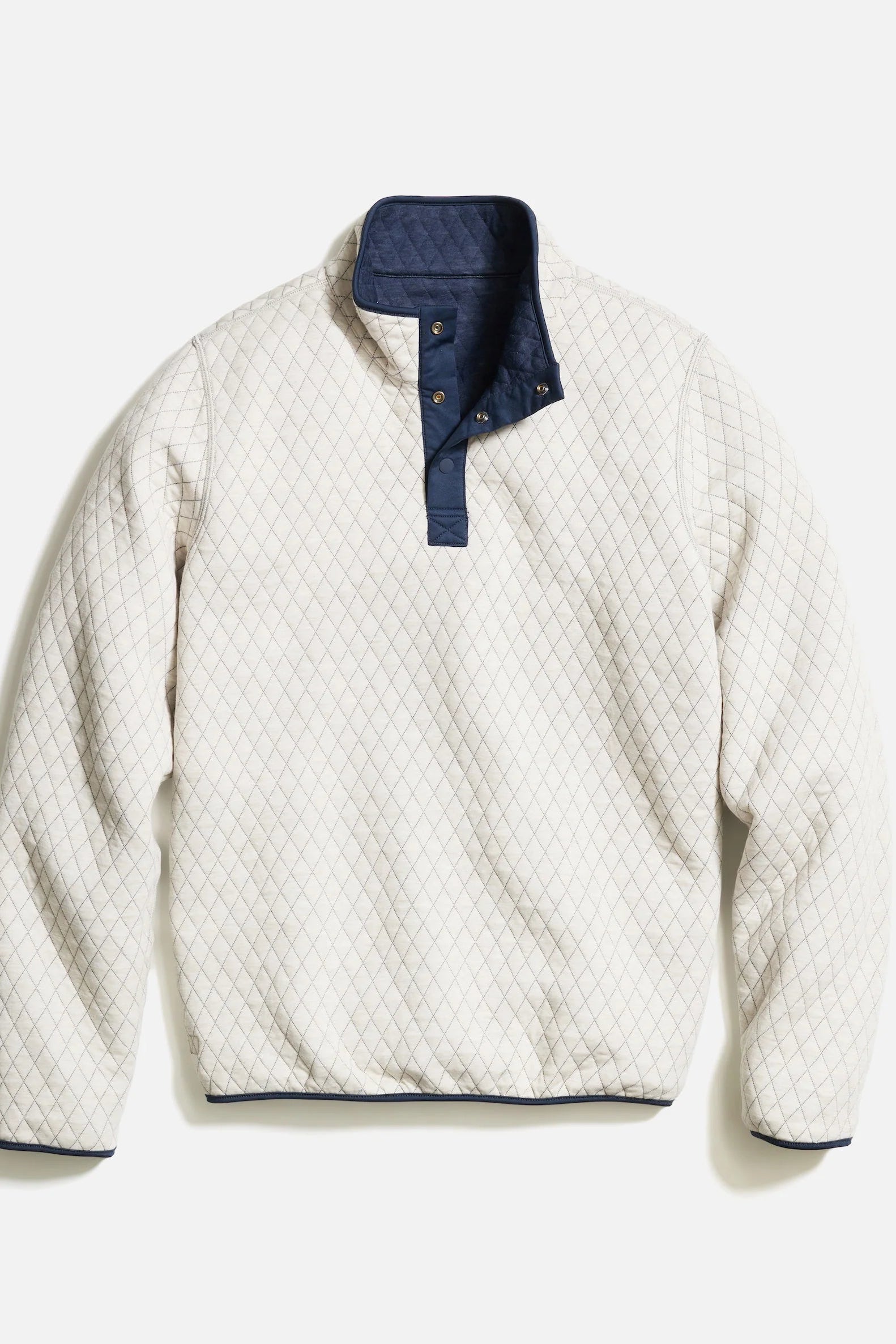 Quilted jacket with navy collar on a white background