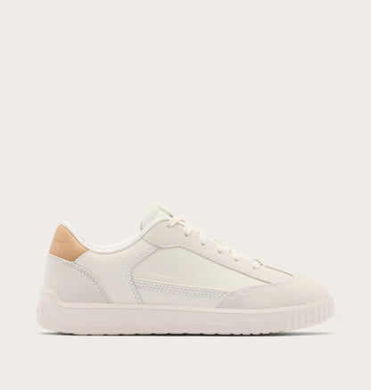 White sneaker with beige accents on a light gray background