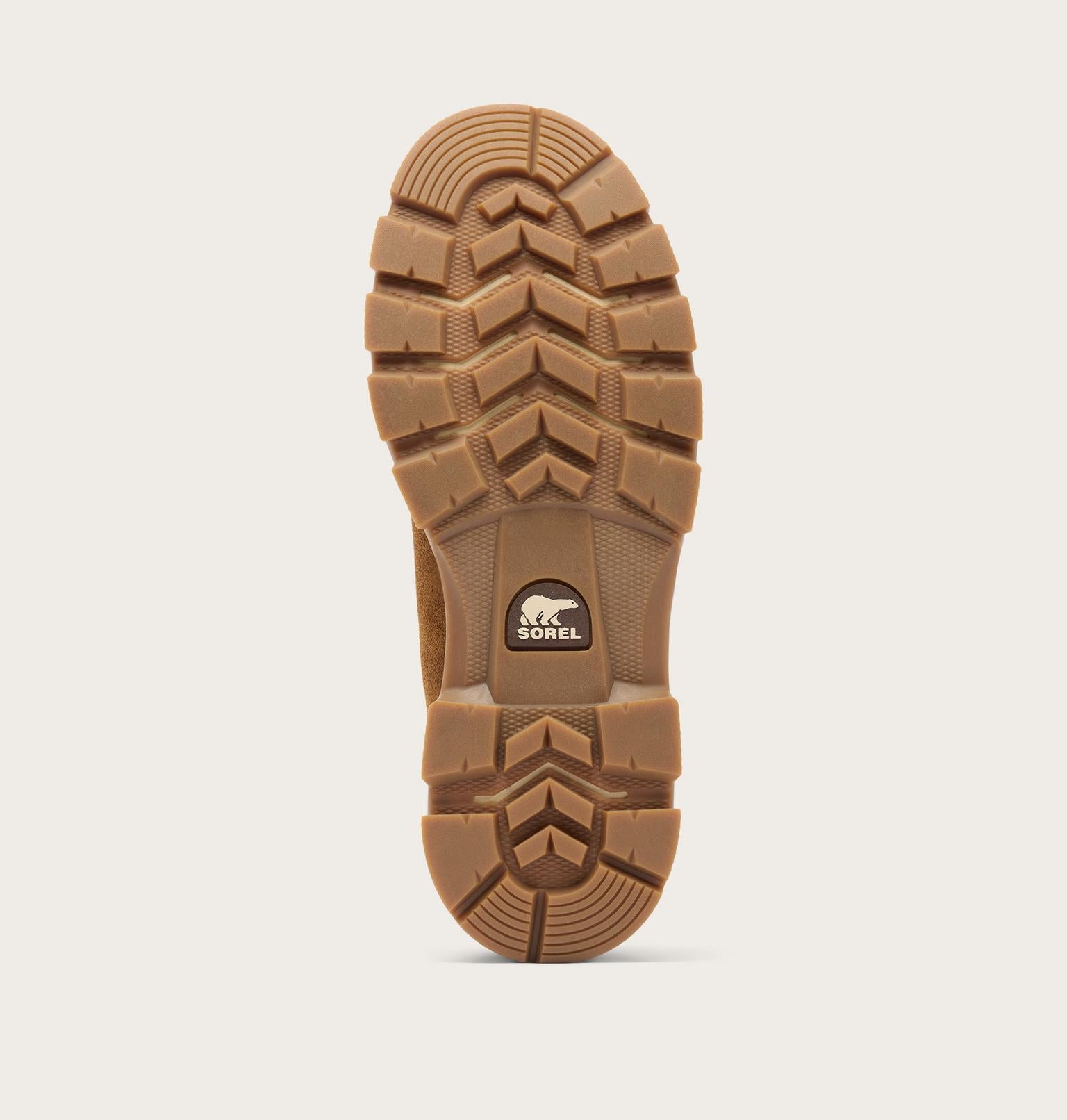 The brown rubber outsole of a boot, showing deep tread patterns and a circular SORREL brand logo on the heel, set against a light gray background.