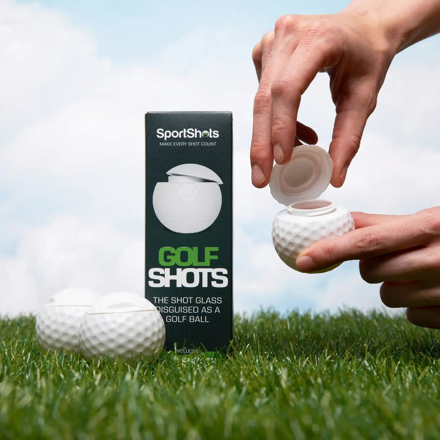 Golf ball shot glass with packaging on grass