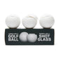 Three golf ball-shaped shot glasses on a black box with text.