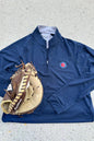 Blue pullover with a logo and a baseball glove on a gray surface