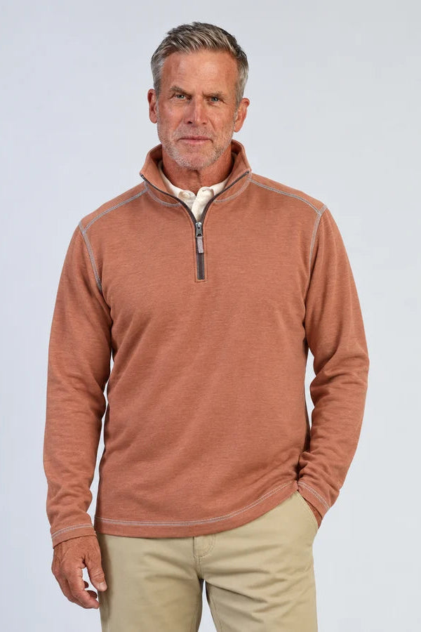 man wearing quarter zip pullover in brick color