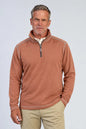 man wearing quarter zip pullover in brick color