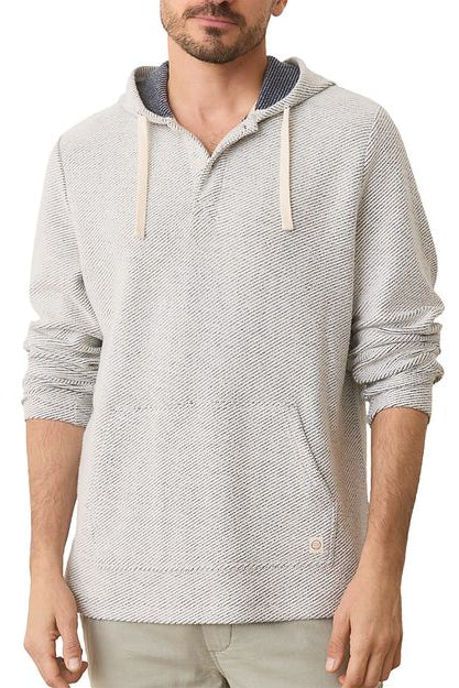 Man wearing a gray hoodie with a visible brand logo on a white background