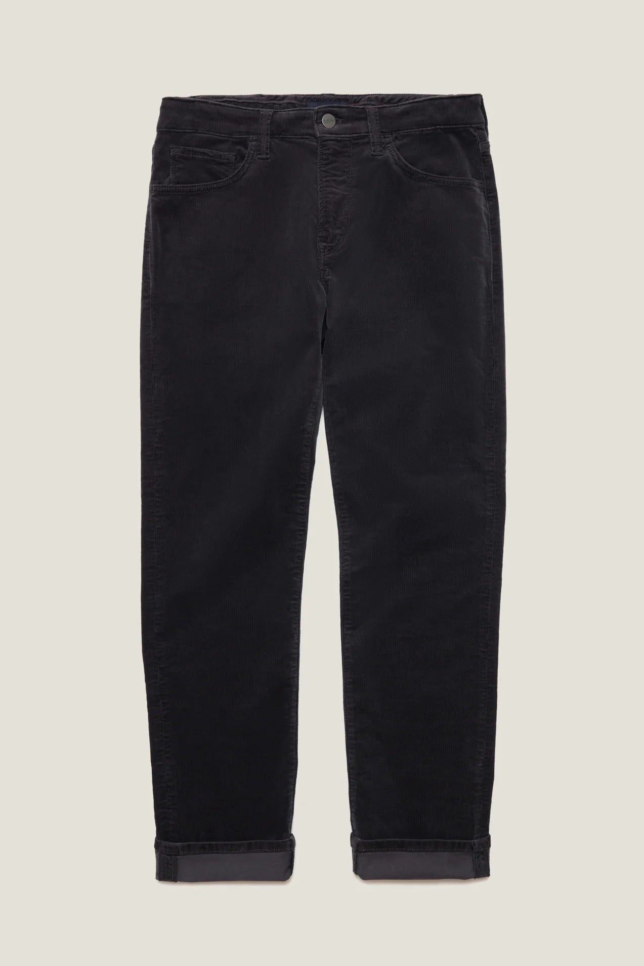 Black corduroy pants with rolled cuffs, displayed flat against a light beige background.