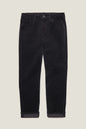 Black corduroy pants with rolled cuffs, displayed flat against a light beige background.