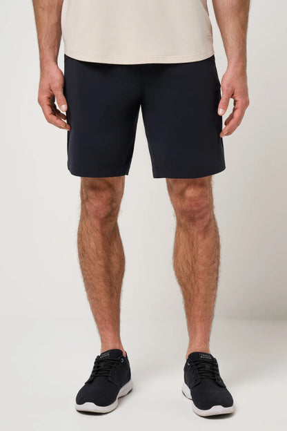Person wearing navy shorts on a plain background