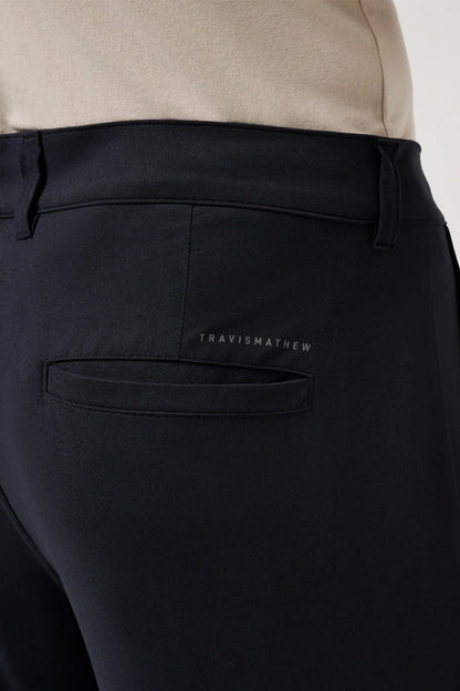 Black pants with a visible brand logo on the pocket against a neutral background