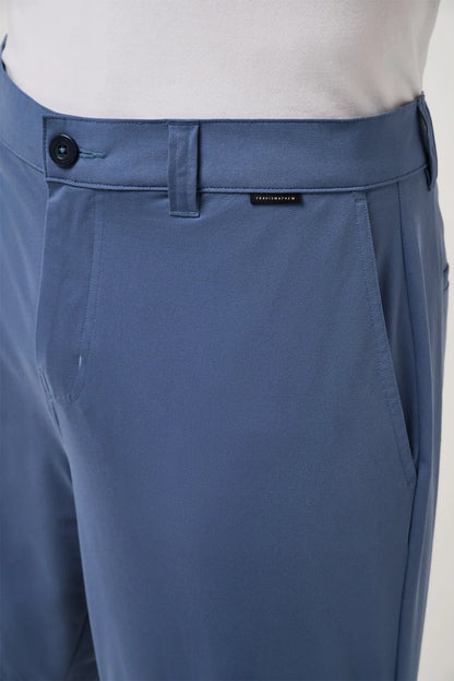 Blue pants with a brand label on a light gray background