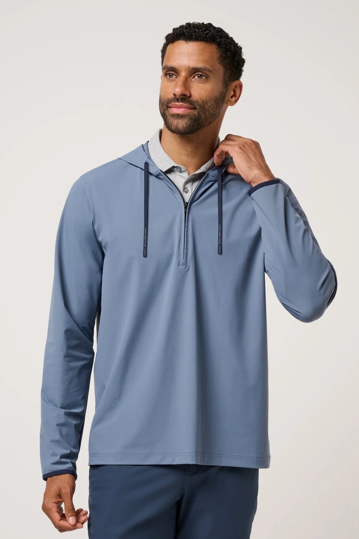 Man wearing a blue pullover with a white background