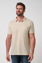Man wearing a beige polo shirt against a plain background