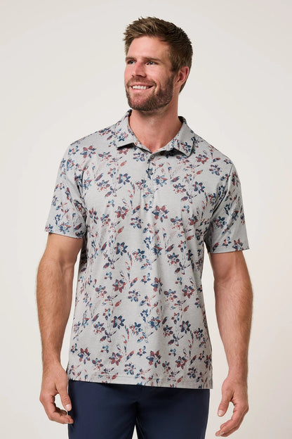 Man wearing a floral patterned shirt against a plain background