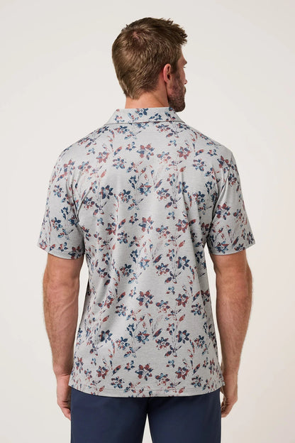 Man wearing a floral short-sleeve shirt on a white background