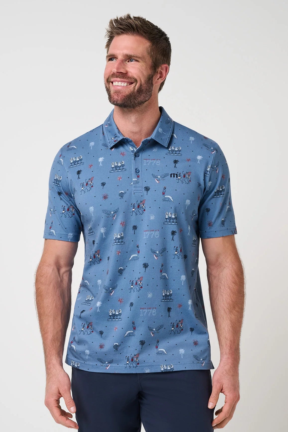 Man wearing a blue patterned polo shirt against a plain background