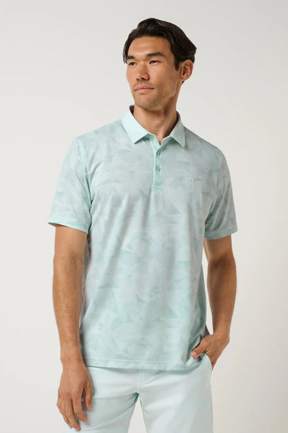 Man wearing a light blue polo shirt and pants against a white background