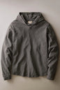 A dark gray hooded long-sleeve shirt with a buttoned placket, laid flat against a neutral beige background.