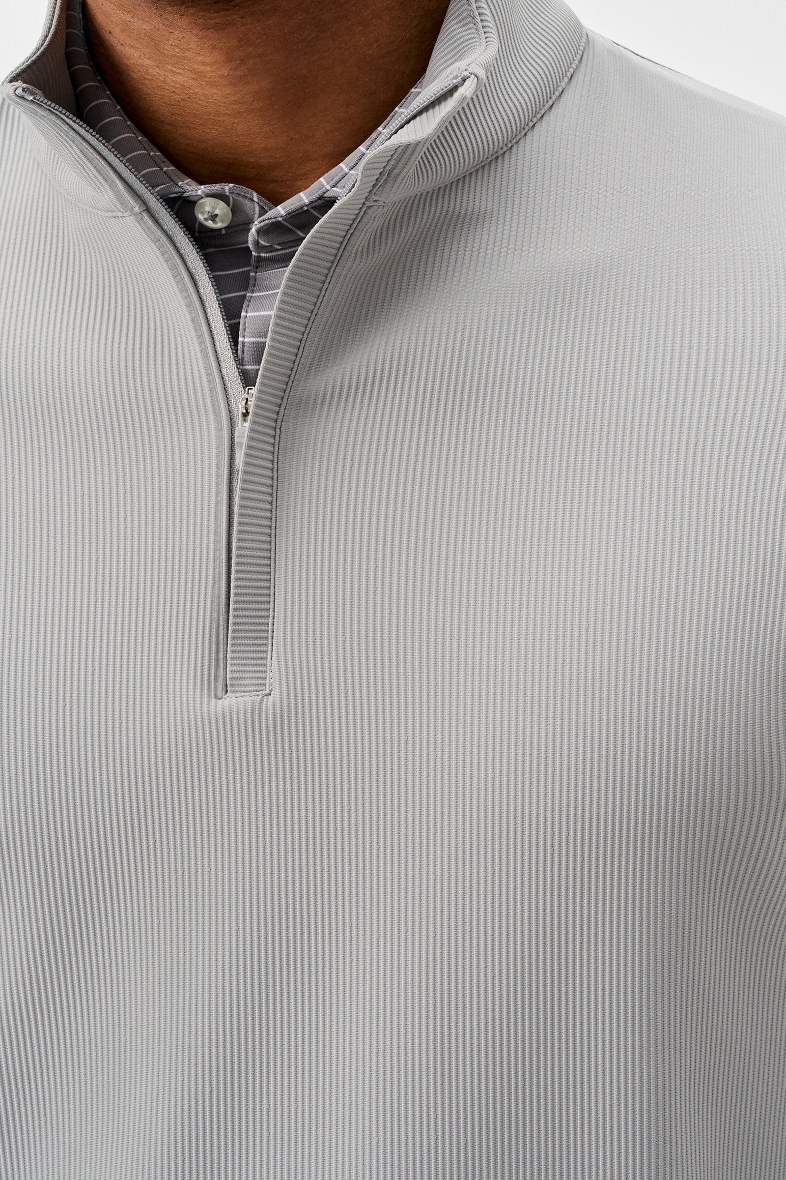 Close-up of a gray ribbed pullover with a quarter zip.