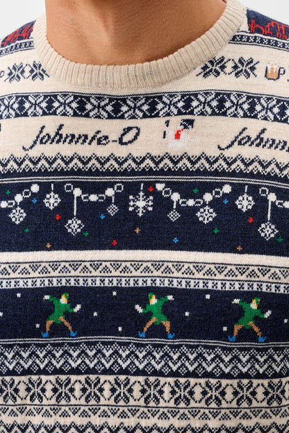 Close-up of a knitted crewneck sweater with a cream base and dark navy horizontal bands featuring snowflake patterns, the text 'Johnnie-O' twice, a snowman, and dancing elves.