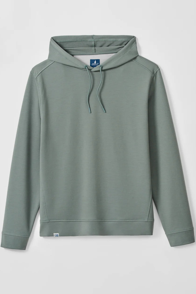A sage green pullover hoodie with matching drawstrings, displayed flat against a light gray background. The hoodie features a small blue brand tag on the inside neck and a tiny white tag near the bottom hem.