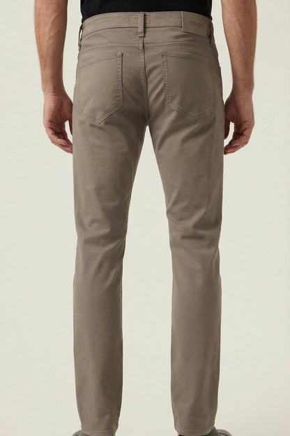 Person wearing beige pants on a plain background