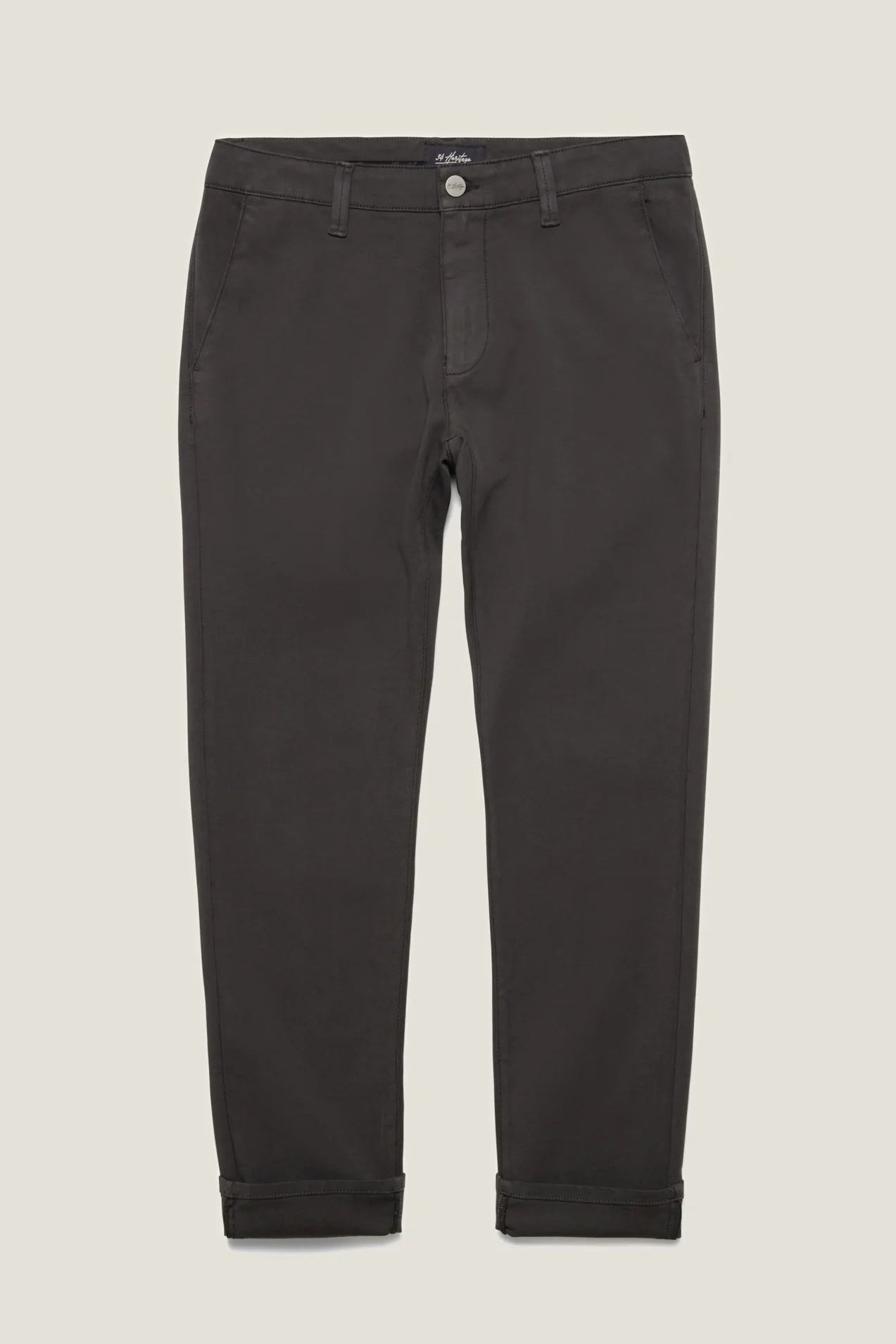 Dark charcoal gray slim-fit trousers with rolled cuffs, shown flat against a light beige background.