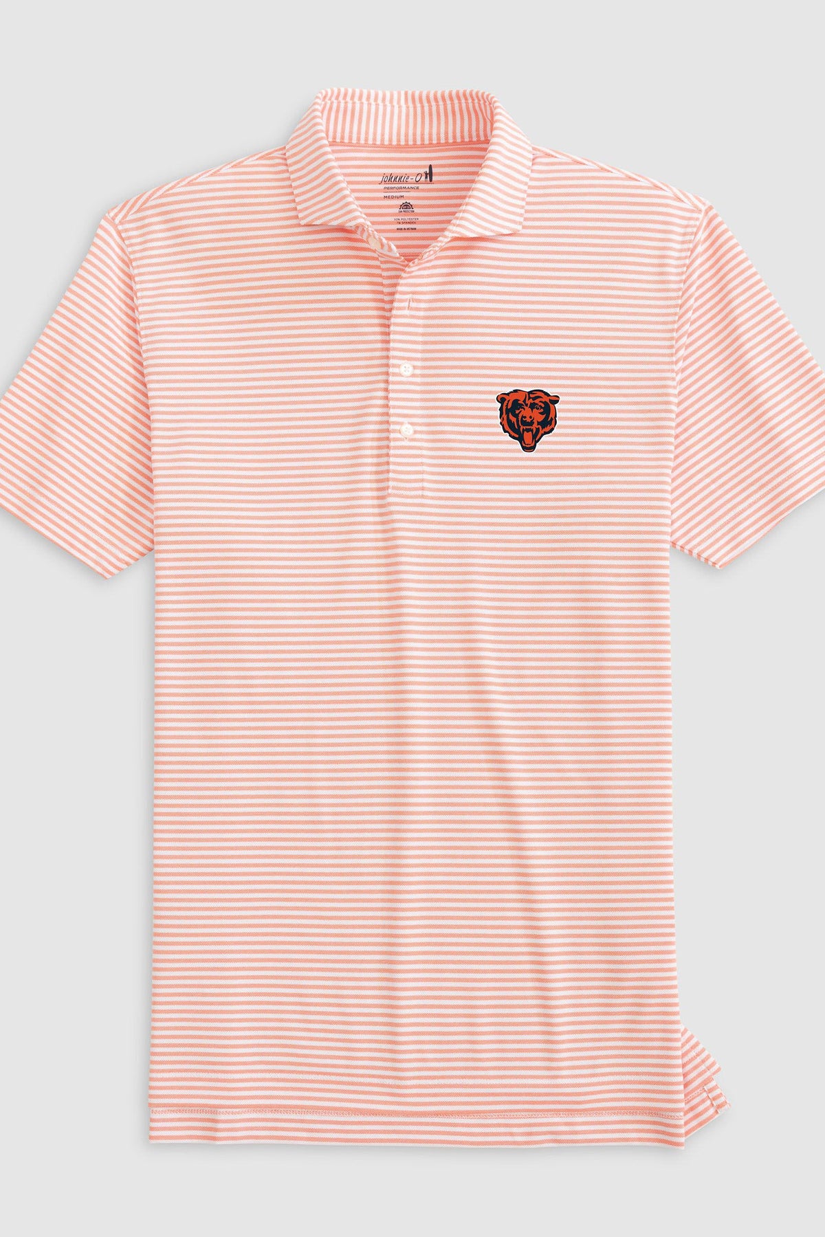 A short-sleeve polo shirt with thin orange and white horizontal stripes, featuring a small embroidered Chicago Bears logo on the left chest, displayed on a light gray background.