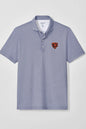 A short-sleeve polo shirt with a fine blue and white vertical stripe pattern, featuring a small embroidered Chicago Bears bear head logo on the left chest, displayed on a neutral light gray background.