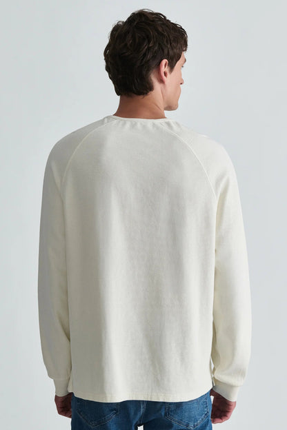 back view of man in white long sleeve shirt and jeans