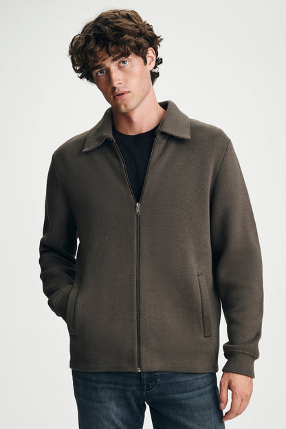 man wearing brown sweater with jeans
