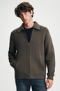 man wearing brown sweater with jeans