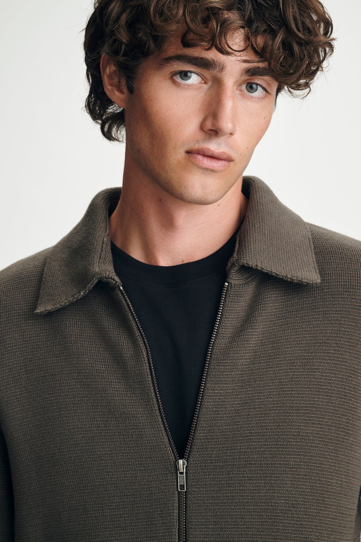 close up of man in brown sweater