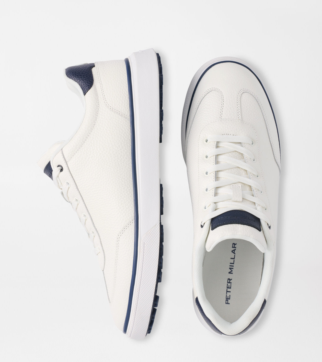 White sneakers with navy accents on a white background