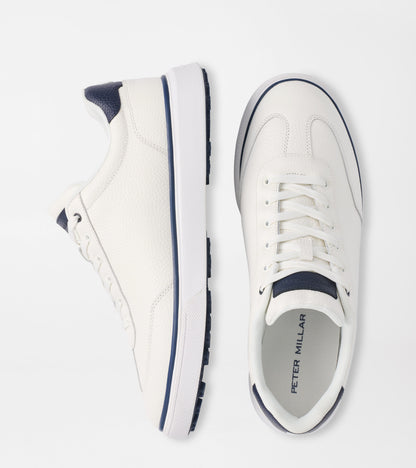 White sneakers with navy accents on a white background