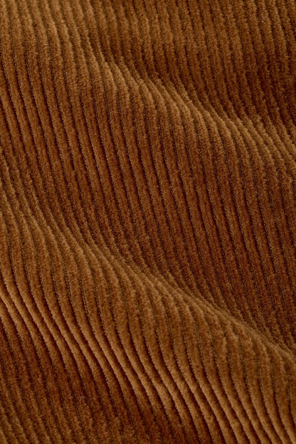 A close-up of a brown corduroy fabric showing the characteristic vertical ribbed texture and soft sheen.