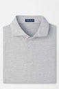 A folded light gray heathered polo shirt by Peter Millar, featuring a classic collar, two-button placket, and a clean white background.