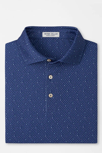 Blue polka dot polo shirt on a light gray background