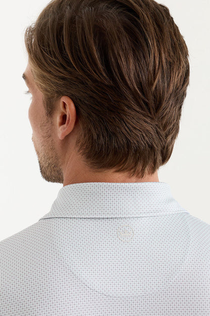 Man wearing a light blue patterned shirt on a white background