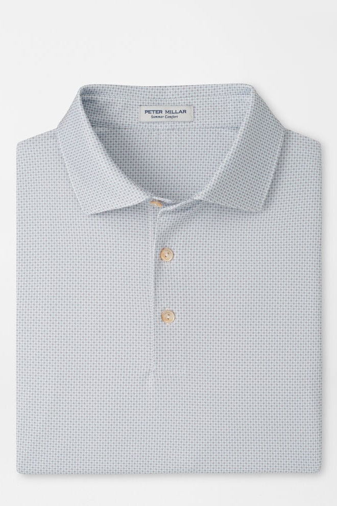 Folded light blue polo shirt with pattern on a white background